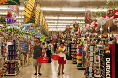 Interior view of the Don Quijote store with an endless number of aisles with produce, gifts, clothing, and packaged food.